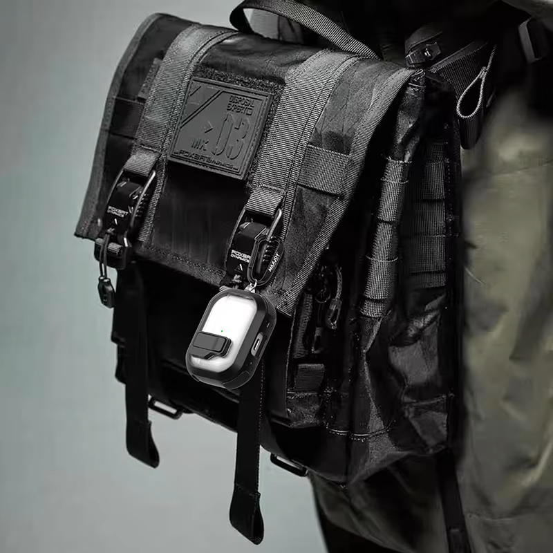 Rugged airpods pro case securely clipped to a black tactical style bag for convenience and accessibility.