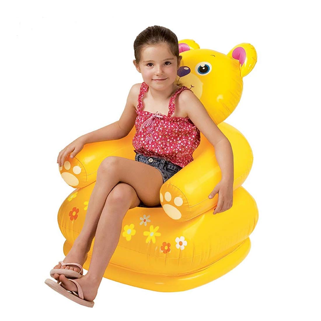 Child enjoying a bright yellow bear themed inflatable chair in a cozy and colorful playroom setting