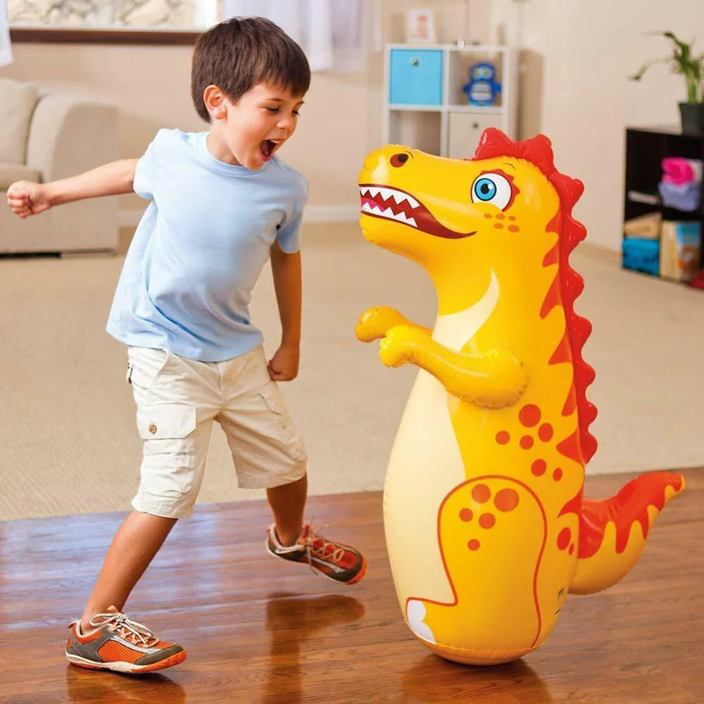 A young boy enjoying a play session with a dinosaur themed inflatable bop bag, promoting active fun.