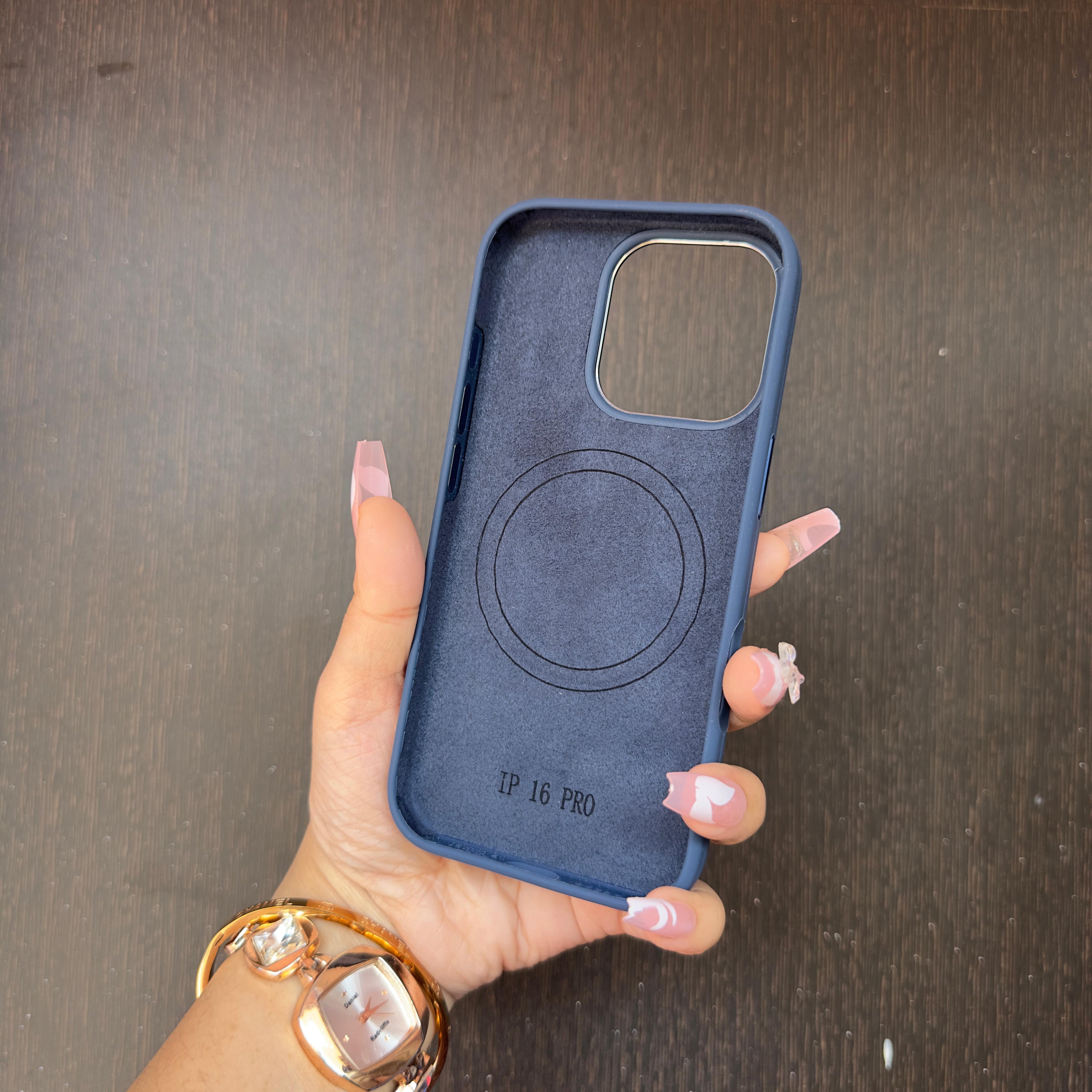Navy blue MagSafe compatible iPhone cover with inner magnetic ring, iphone 16 pro case held in hand to show texture and padding.