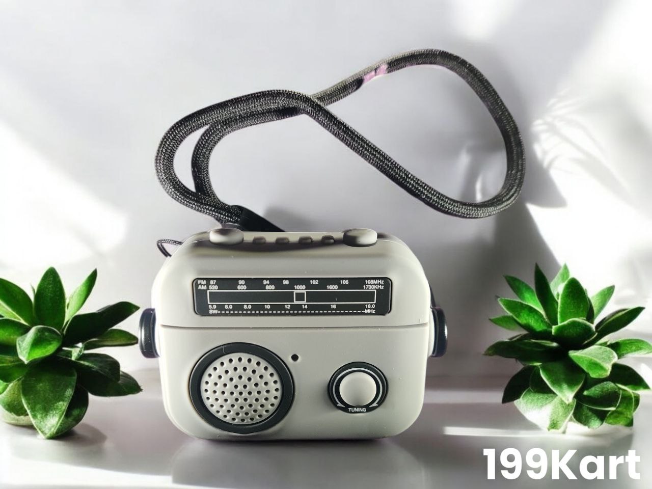 Light grey airpods pro 2 case styled like a vintage radio, featuring a black strap