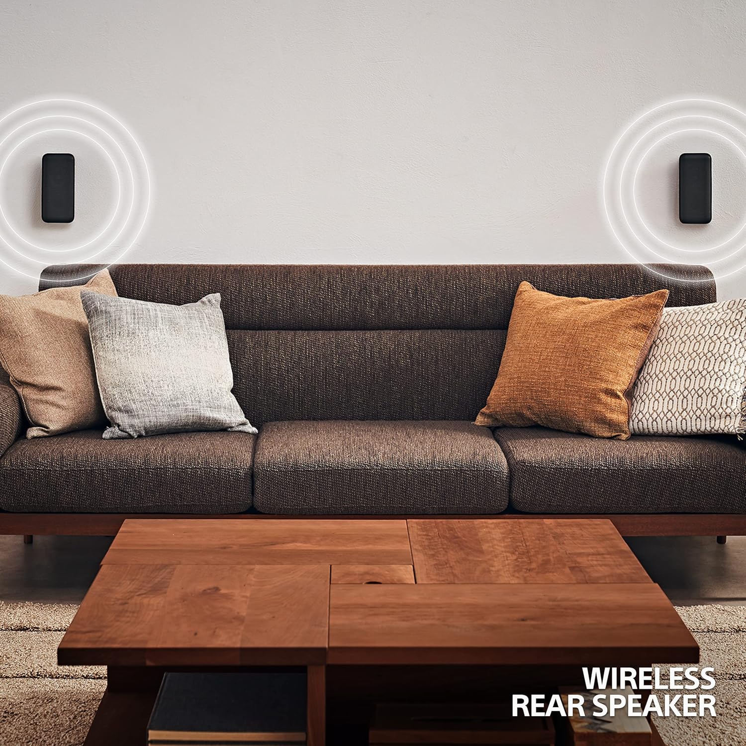 Rear speakers mounted on the wall delivering wireless surround sound with the Sony HT S40R system in a cozy living room.