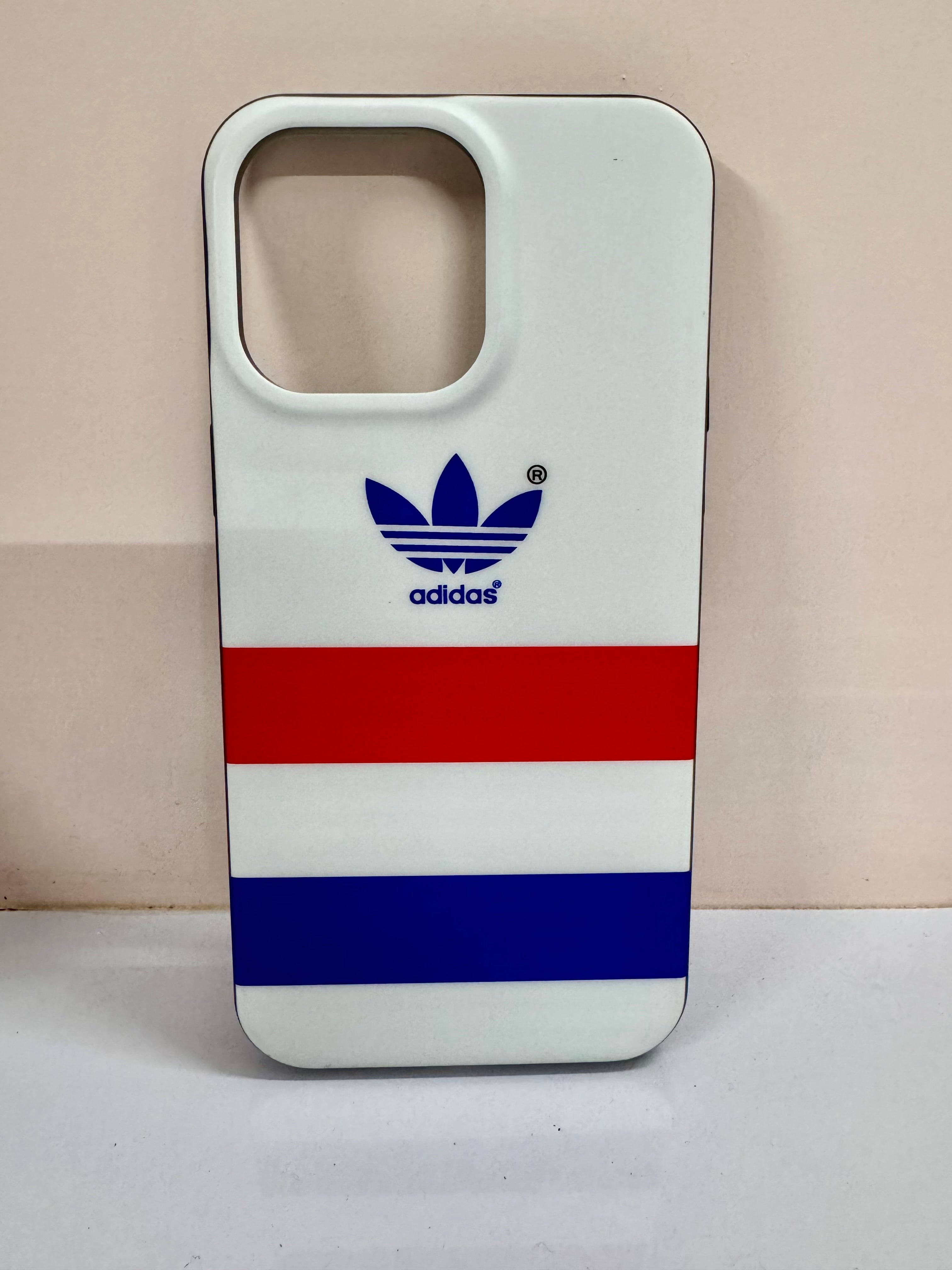 A sleek white iPhone cover with red and blue stripes and a bold Adidas inspired logo, iphone 15 pro max case offering a sporty and trendy look