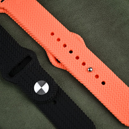 A stylish Apple Watch featuring a black and orange band perfect for tech enthusiasts.