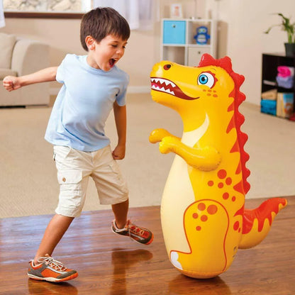  A young boy enjoying a play session with a dinosaur themed inflatable bop bag, promoting active fun.