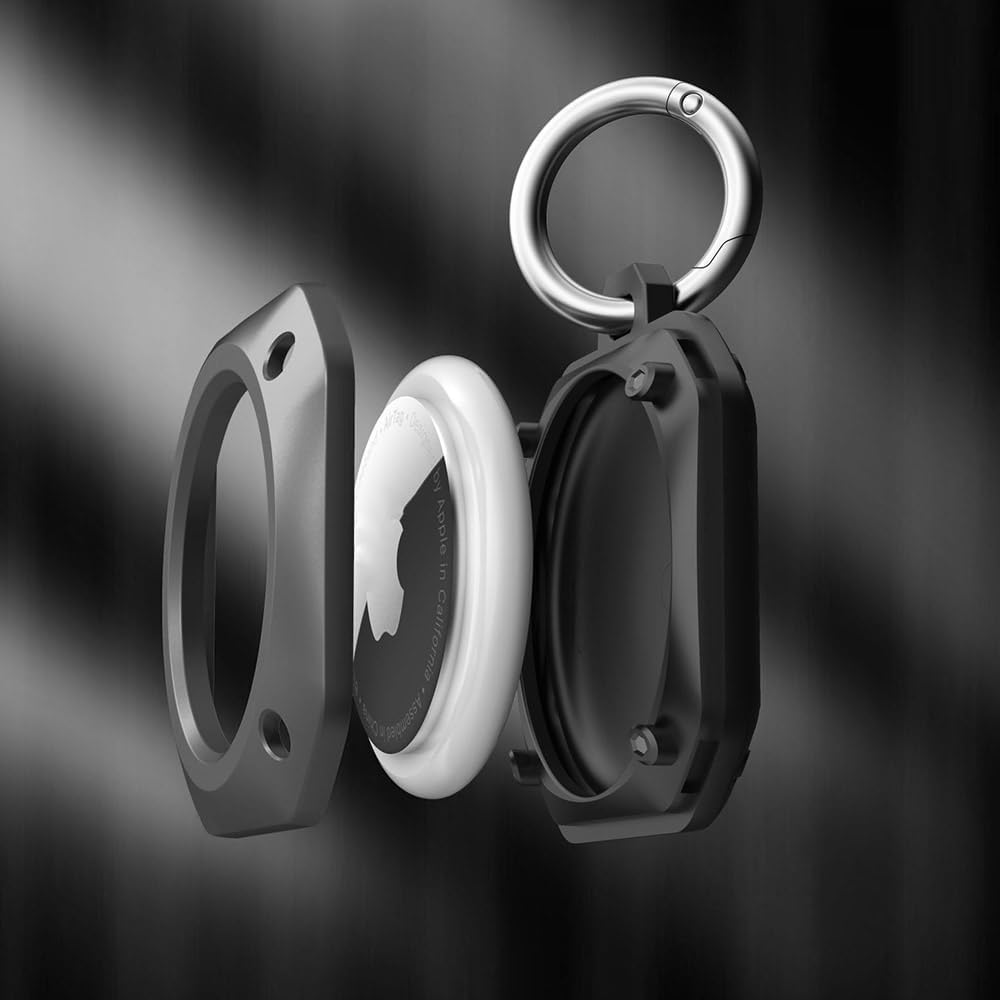 Exploded view of a rugged black AirTag case with a keychain ring, showing how the AirTag fits securely between protective covers