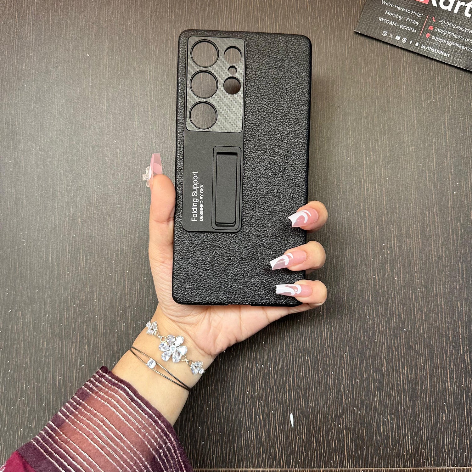 Stylish black leather Samsung cover with a foldable stand and precision camera cutout, held in hand for S25 Ultra