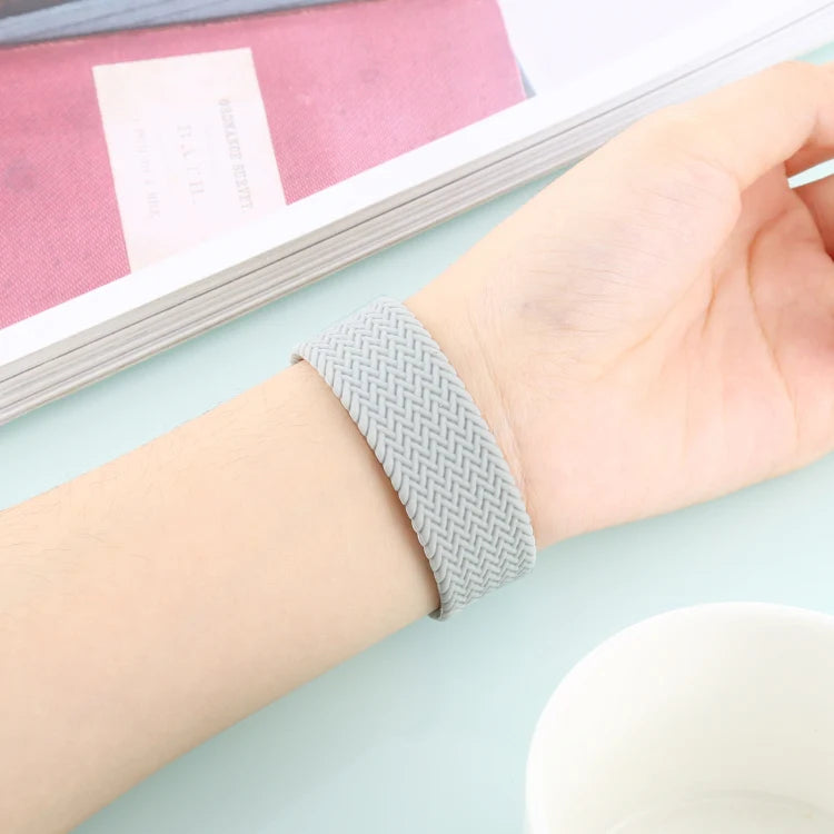 Grey braided loop strap worn on wrist, apple watch straps offering comfort and secure fit for Apple Watch users.