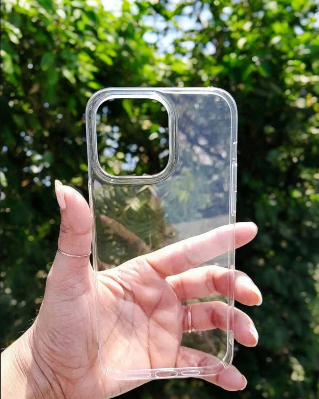  A close up of a hand holding a clear iPhone case, iphone 15 pro max cases highlighting its minimalist style and protective features.
