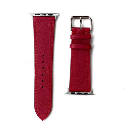 A detailed view of a red leather apple watch straps, complete with a shiny silver buckle for a chic look.
