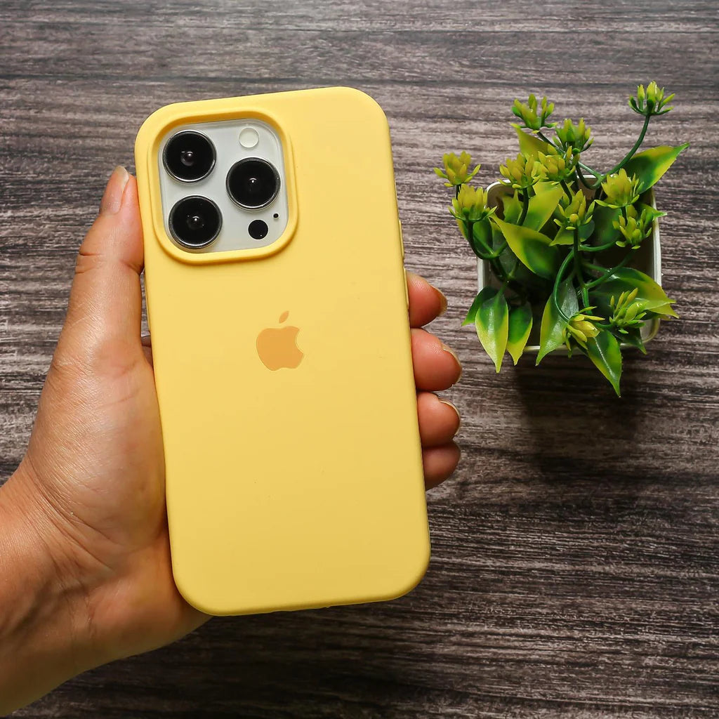 A hand holds several bright yellow apple covers , iphone 15 pro max cover highlighting their stylish and modern appearance.