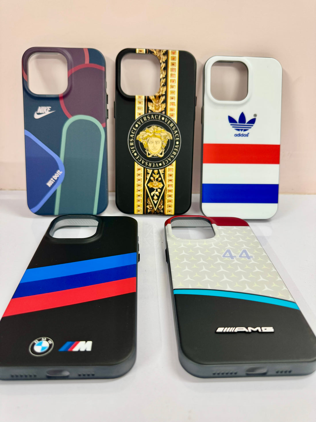  A set of premium iPhone covers with exclusive luxury inspired prints, including BMW M Sport, Adidas, Nike, and Versace themes. for iphone 15 pro max cover