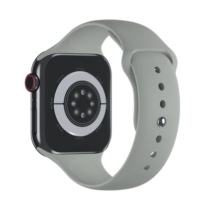 A sleek apple watch straps with a grey soft silicone strap, shown from the back to highlight the sensor and strap holes