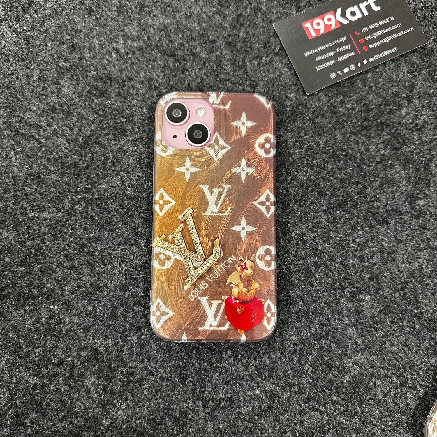 Designer iPhone case in glossy jgold with gold metallic detailing and the LV stone logo embossed at the center for iphone 15 pro covers