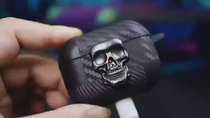 Black carbon fiber AirPods Pro case with a bold metal skull emblem, airpods pro 2 case that&